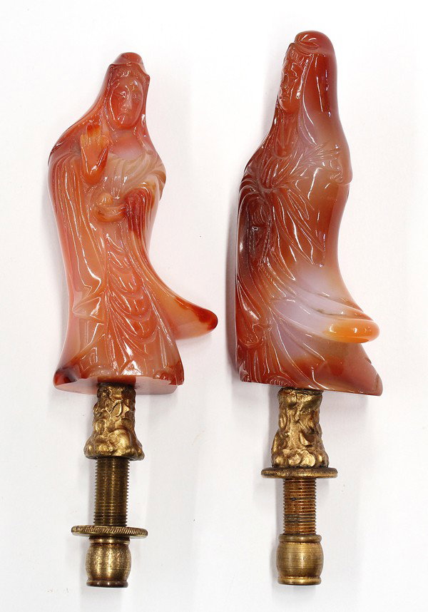 Chinese Chalcedony Bodhisattva Carvings: (Lot of 2) Chinese figural chalcedony carvings, each modeled as a Guanyin draped in tiers of cascading robes, one holding a chain of prayer beads, the other clutching a sacred jewel and with her right