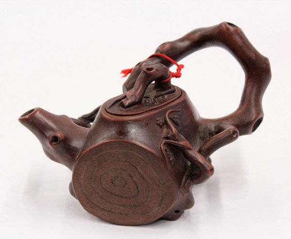Chinese Zisha Teapot, Marked Chen Guoliang, Prunu: Chinese Yixing zisha ceramic teapot, fashioned as a section of a tree trunk with a gnarled branch forming the handle and spout accented with small blossoms, the recessed base impressed 'Chen Guoliang'
