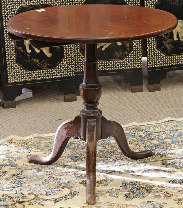 Chippendale tea table: Chippendale walnut tea table circa 1760, the later circular single board top above a turned urn form standard rising on a tripod base terminating on snake feet, 26"h x 27"w