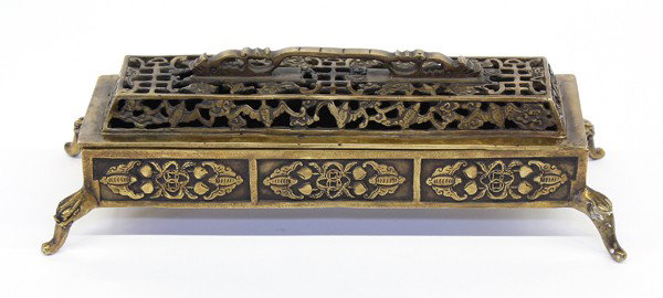 Chinese Rectangular Metal Censer: Chinese rectangular bronze-colored censer, the fitted top with an ornate handle and pierced with shou characters amid bats and clouds, the lower section with recessed panels featuring further bats fla