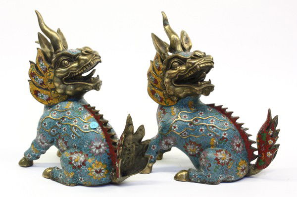 Pair of Chinese Cloisonne Qilin Figures: Pair of Chinese cloisonne enameled qilin, fashioned with a dynamic gilt metal face topped with a pair of pointed ears bracketing a single horn, the turquoise enameled body accented with lotus and whit