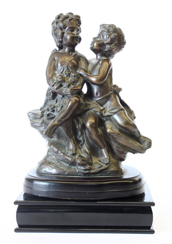 Patinated metal figural Group: Bronze figural group modeled as two putti seated on a naturalistic base, signed August Moreau, mounted to a plinth, 8'h