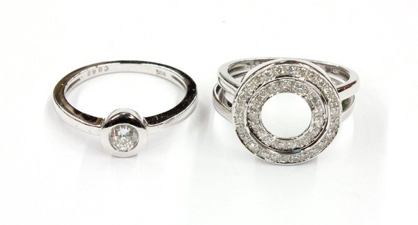 Three diamond set 14k White Gold Rings: Three diamond set rings; mounted in 14k white gold, (2) with diamond framed ''O'' crown, (1) solitaire old European cut diamond set ring, weighing approximately 0.40 ct. Total weight 8.7 grams. Ring s