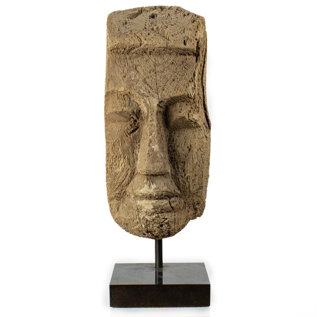 An Egyptian Wood Mask: An Egyptian Wood Mask, or possibly the main central fragment as the edges are flat and lacking ears, but with the eyes, long straight nose, and mouth have a certain straightforward countenance, appear