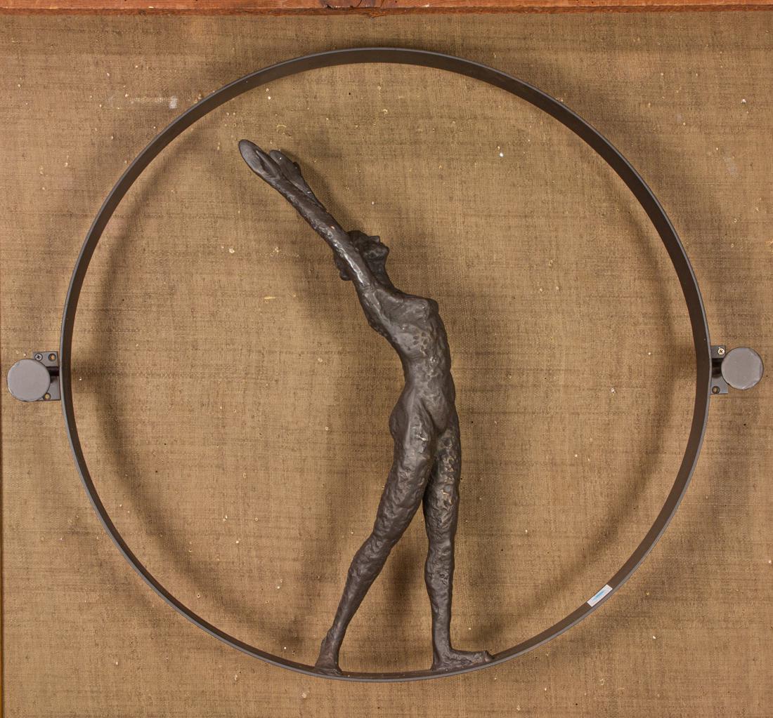 Sculpture of a female acrobat: Sculpture of a female acrobat, modeled balanced within a hoop, with wall mount, 29"h x 24.5"w x 7"d.