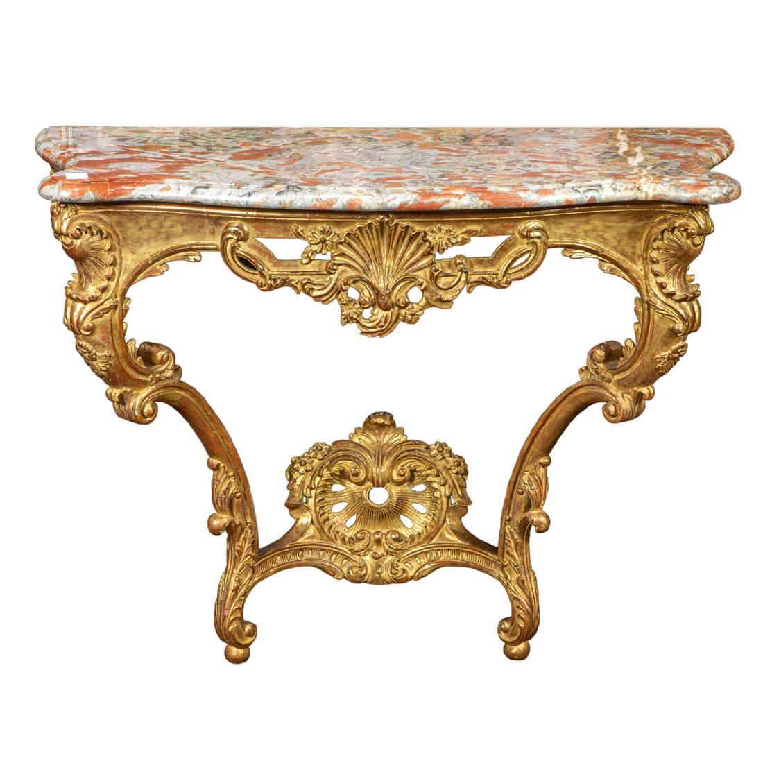 A pair of French giltwood console tables: A pair of French giltwood console tables, executed in the Rococo taste, each having a shaped marble top, above the apron centered with a shell, continuing to scrolled legs having acanthus accents, 35"