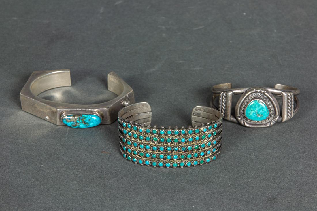 Three Navajo turquoise and sterling cuff bracelets, one marked 'DC', total weight 140 grams: Three Navajo turquoise and sterling cuff bracelets, one marked 'DC', total weight 140 grams