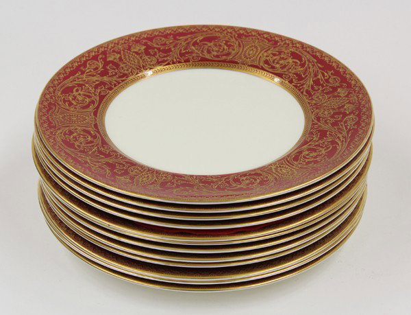 Royal Worcester service plates: (lot of 12) Royal Worcester 'Embassy' porcelain service plates, each having a crimson border accented with applied gilt highlights of floral swags centering the geometric medallions on a cream ground,