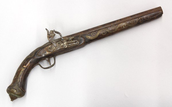 Middle Eastern flintlock pistol: Middle Eastern flintlock pistol, probably late 18th/early 19th century, with a 10.5'' round barrel, the stock and ball butt decorated with brass, and scrolling brass wire, overall: 18''l