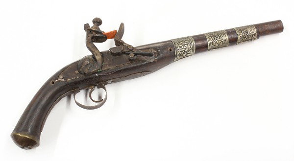 Middle Eastern flintlock pistol: Middle Eastern flintlock pistol, probably late 18th/early 19th century, with a 11'' round barrel with three engraved capucines, the stock and ball butt decorated with brass, and scrolling brass wire, 