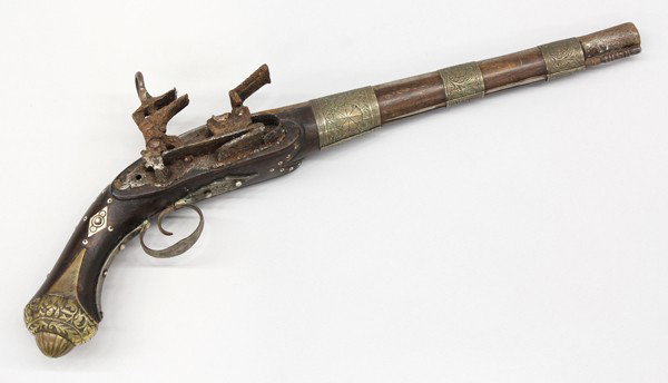 Middle Eastern flintlock pistol: Middle Eastern flintlock pistol, probably late 18th/early 19th century, with a 12.5'' round barrel, with three engraved capucines, the stock and ball butt decorated with brass, and inlaid mother-of-pe