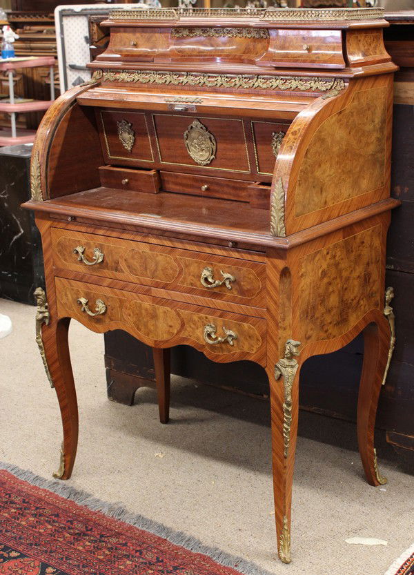 Louis XV style roll top desk: Louis XV style bronze mounted roll top desk, the inlaid case having a tambour lifting to the fitted interior above a two drawer case and rising on cabriole legs having figural mounts , terminating on