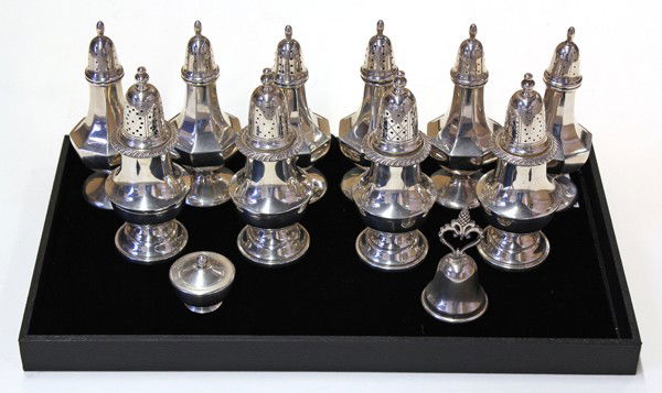 American sterling table accessories: (lot of 22) American sterling silver table accessories including five pairs of salts and peppers by Fisher and Redlich & Company; four pairs of wood lined salts and peppers; bell, covered salt cellar,