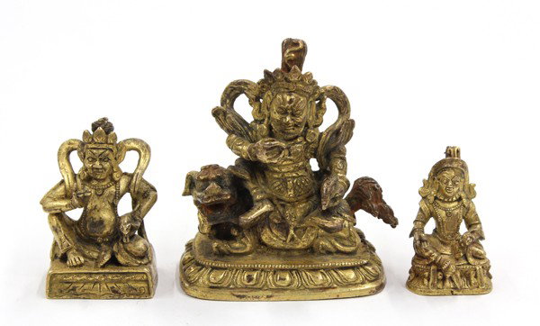 Two Himalayan Gilt Metal Kubera Figures: (Lot of 3) Gilt copper-alloy figures of Kubera, the God of Wealth, each with a marshall aspect and seated with a mongoose, the larger in armor and resting on the back of a fu-lion, with traces of pigm
