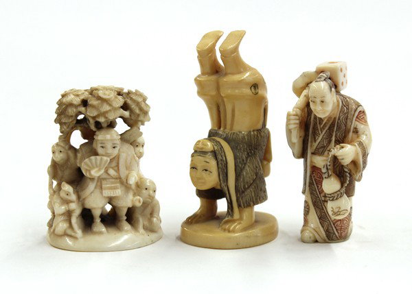 Japanese Netsuke: (Lot of 3) Japanese figural netsuke, the first depicting Kintoki accompanied by his animals and bird-headed followers, signed; a small figure of a townsman returning from a festival, polychrome accent