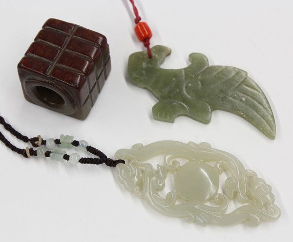 Chinese Jade Toggles and Cong: (Lot of 3) Chinese jade decorations, including: a russet, gray-green 'cong' with each side forming two columns of four registers; a gray-green hue plaque shaped as a stylized bird; and one celadon jad