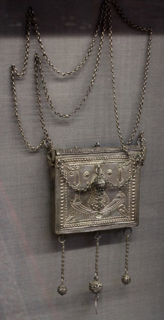Middle Eastern Silver Amulet: Framed silver amulet, Middle Eastern or Coptic, of square form chased with table decorations and embellished with reticulated beads suspended to the front and from the bottom together with an Arabic c