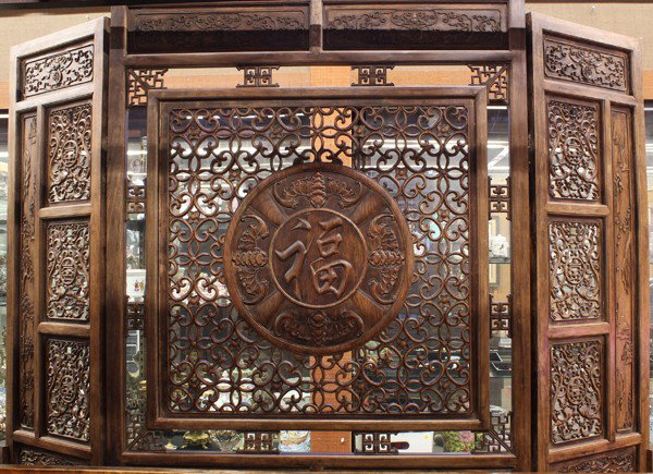 Chinese Large Reticulated Wooden Screen: Chinese large three-panel openwork wooden screen, the central panel featuring the character 'fu' (good fortune) encircled by five bats amid a pierced geometric ground and above a lower section carved 