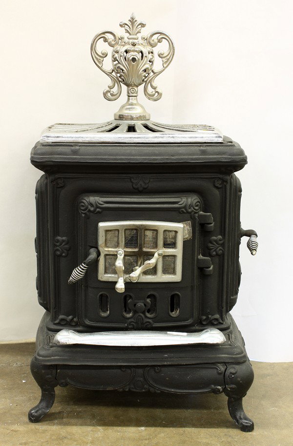 Vintage cast iron wood stove: Vintage cast iron wood stove, with a chromium finial, decorated with pierced acanthus, marked on reverse ''Den Stove'', 38'' x 21''w x 18''d