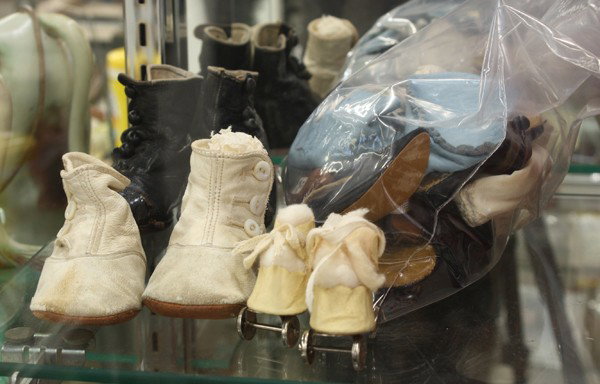 Doll clothing and accessories: Collection of doll clothing and accessories including skates, shoes, socks, hats, and sweaters