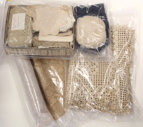 Vintage lace accessories: Three bags containing a collection of vintage lace accessories and coverlets including place mats, tray linens, and doilies