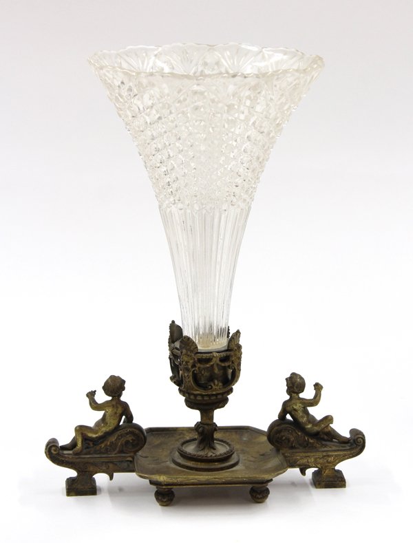 Renaissance style epergne: Renaissance style epergne circa 1870, having a pressed trumpet form insert above a patinated metal base accented with reclining putti mounts and rising on a footed base 10''h x 8''w