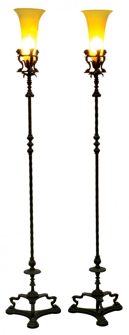 Steuben torchieres: (lot of 2) Steuben glass and patinated bronze floor lamps, the acid cut yellow jade shades decorated with garland swags suspending the hanging pendant against a textured ice tapered body, rising on a