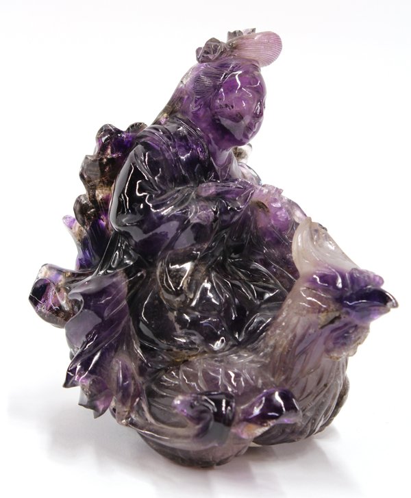 Chinese Amethyist Figural Carving of Queen Mother: Chinese amethyst carving of Xi Wang Mu (Queen Mother of the West), the female deity portrayed riding on a large phoenix with a basket of flowers suspended from her hands, the translucent light and dar