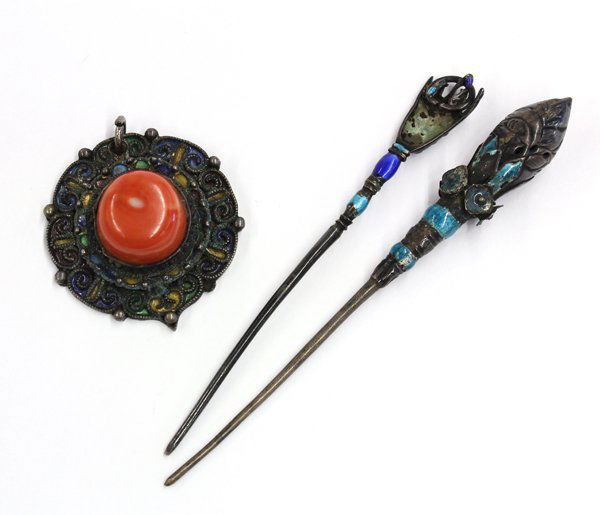 Asian Enameled Hair Pin and Ornament: (Lot of 3) Asian hairpins and toggle: the first an enamel accented filigree framing a coral cabochon; the second, a pin shaped with a hand clutching a ring; the third, with a bud finial accented with