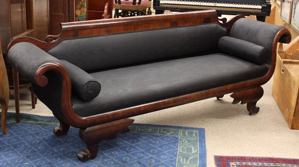 American Empire settee: American Empire settee, executed in mahogany circa 1830, the horozontal crest continuing to the swans neck arms and having noir silk upholstery, rising on stylized legs terminating on outswept feet, 3