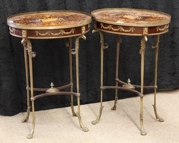 Neoclassical style gueridons: Pair of Neoclassical style gilt bronze mounted gueridons, circa 1900, the oval marquetry decorated top having floral sprays surrounding the central frieze of musical instruments, above a single blind 