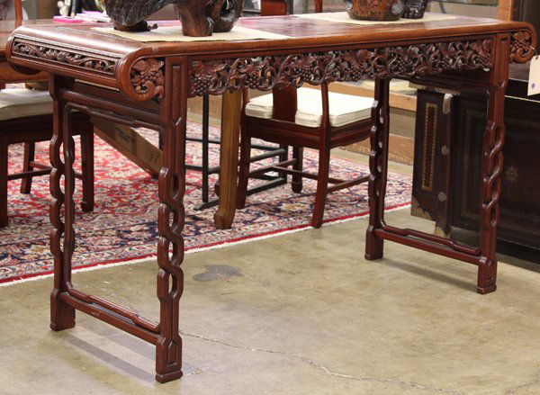 Chinese Large Hardwood Side Table: Chinese large hardwood side table, with a floating rectangular top flanked by downward scrolling ends accented with narrow reticulated panel of bats and suspending a pierced apron of fruiting grape vi
