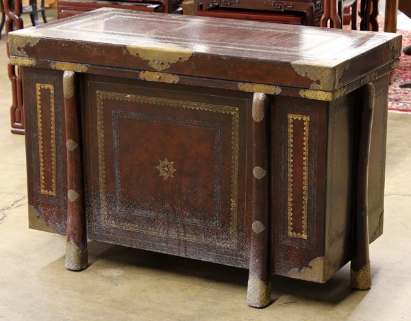 Leather Bound Anglo-Indian Chest: Anglo-Indian inspired leather bound chest, the rectangular body raised on six splayed supports and with a hinged lid, covered in dark leather punched with foliate patterned bands with occasional gilt 