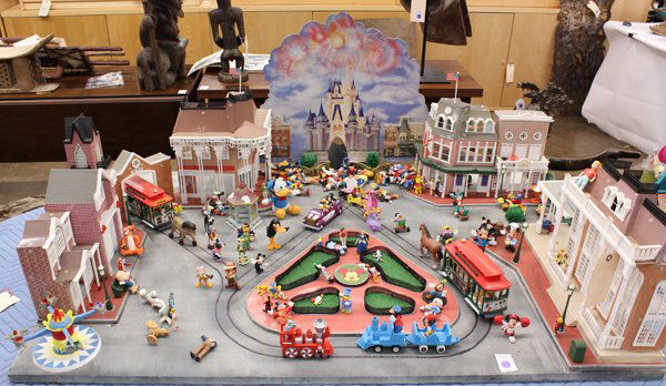 Disneyland scale model: Disneyland scale model of Main St., showing some of the landmarks of the park including Emporium, Fire Station, Car Barn, Dumbo ride, and a backdrop of Cinderella's castle, includes an assortment of D