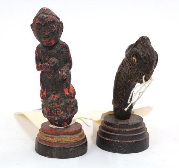 Pair of Sasak handle from Lombok: (lot of 2) Sasak, Lombok, handles for a betel nut crusher, one carved as a wood figure having black and red pigments, the other one having a curved bird head and a warrior's face, tallest 6.5''h. Prov