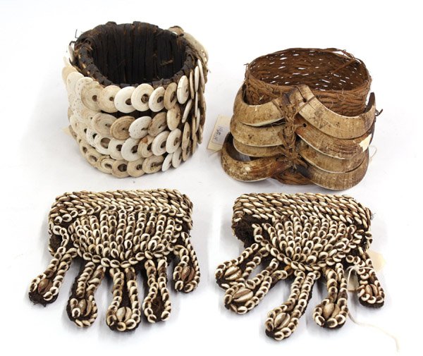 New Guinea armbands and hand decorations: (lot of 3) Collection of New Guinea body decorations, including two associated armbands decorated with native shells and pig tusks; together with a pair of hand accessories made of plant threads and c