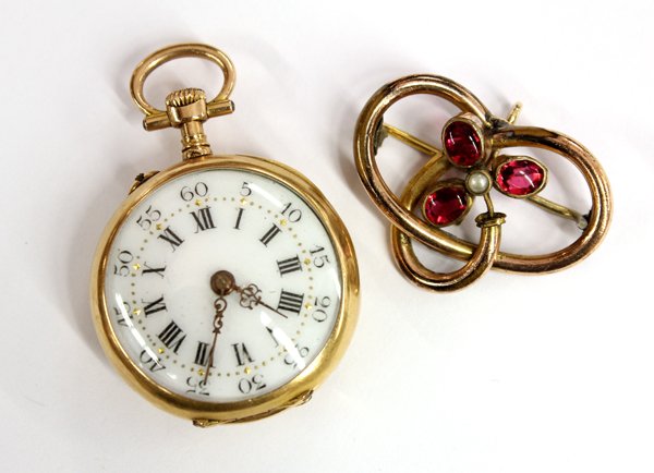 Open face yellow gold ladies pocket watch: Lady's open face lapel watch; in 18k yellow gold, with white enameled dial, black Roman chapters with black Arabic five seconds outter ring, gold second markers and filigree hands. The 26mm case is de