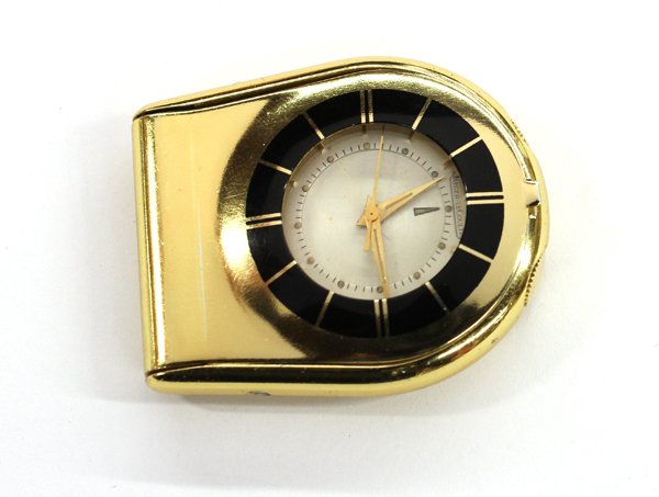 Jaeger-LeCoultre travel alarm clock: Jaeger-LeCoultre folding travel alarm clock; in gilt, outer bezel in black, manual wind. Numbered 570002 on reverse (doesn't appear to be running)