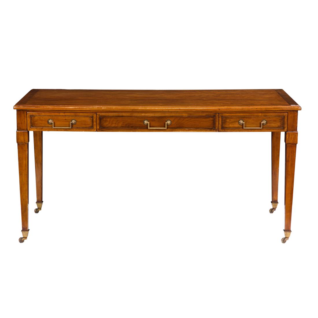 A Louis XVI style bureau plat: A Louis XVI style bureau plat, with three drawers and rising on square tapered legs terminating on casters, 29"h x 59"w x 28"d