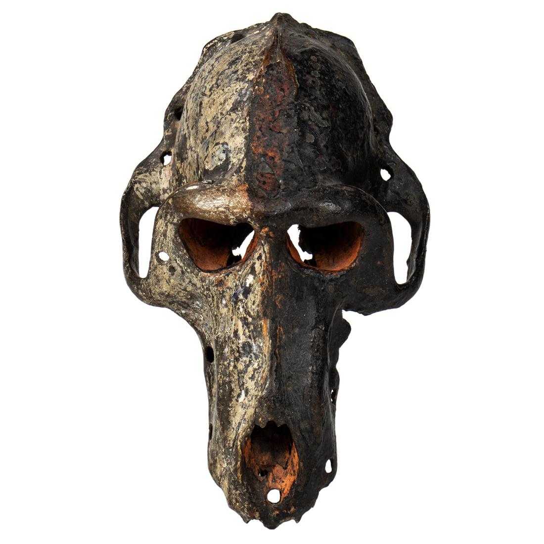 A monkey skull fetish painted symbolically with orange (1 of 3)