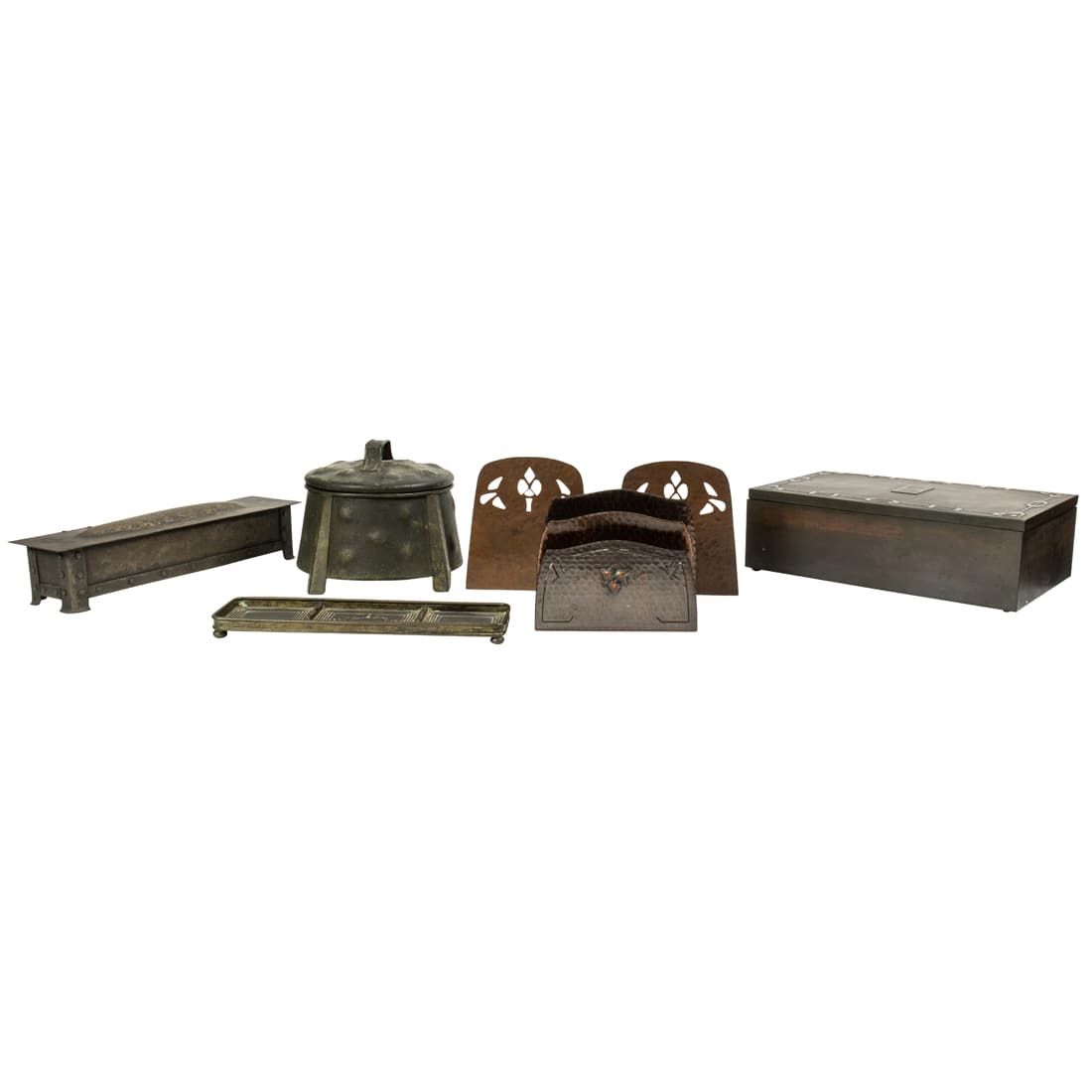 Six Arts and Crafts bronze or copper desk items including: Six Arts and Crafts bronze or copper desk items including: a Tiffany Studios pen tray, a pair of unmarked copper bookends, an Apollo Studios covered humidor, an unmarked letter holder and a Heintz ste