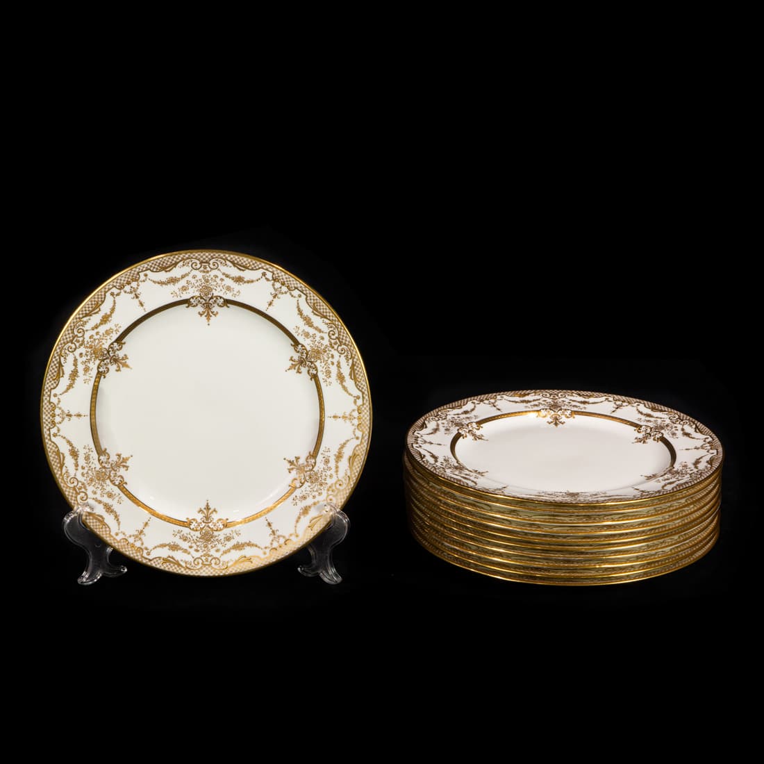 A set of 11 Royal Doulton porcelain service plates retailed by Shreve & Co.: A set of 11 Royal Doulton porcelain service plates retailed by Shreve & Co., San Francisco, early 20th century, each decorated with gilt scrolled and garlanded borders, printed factory marks, and pain
