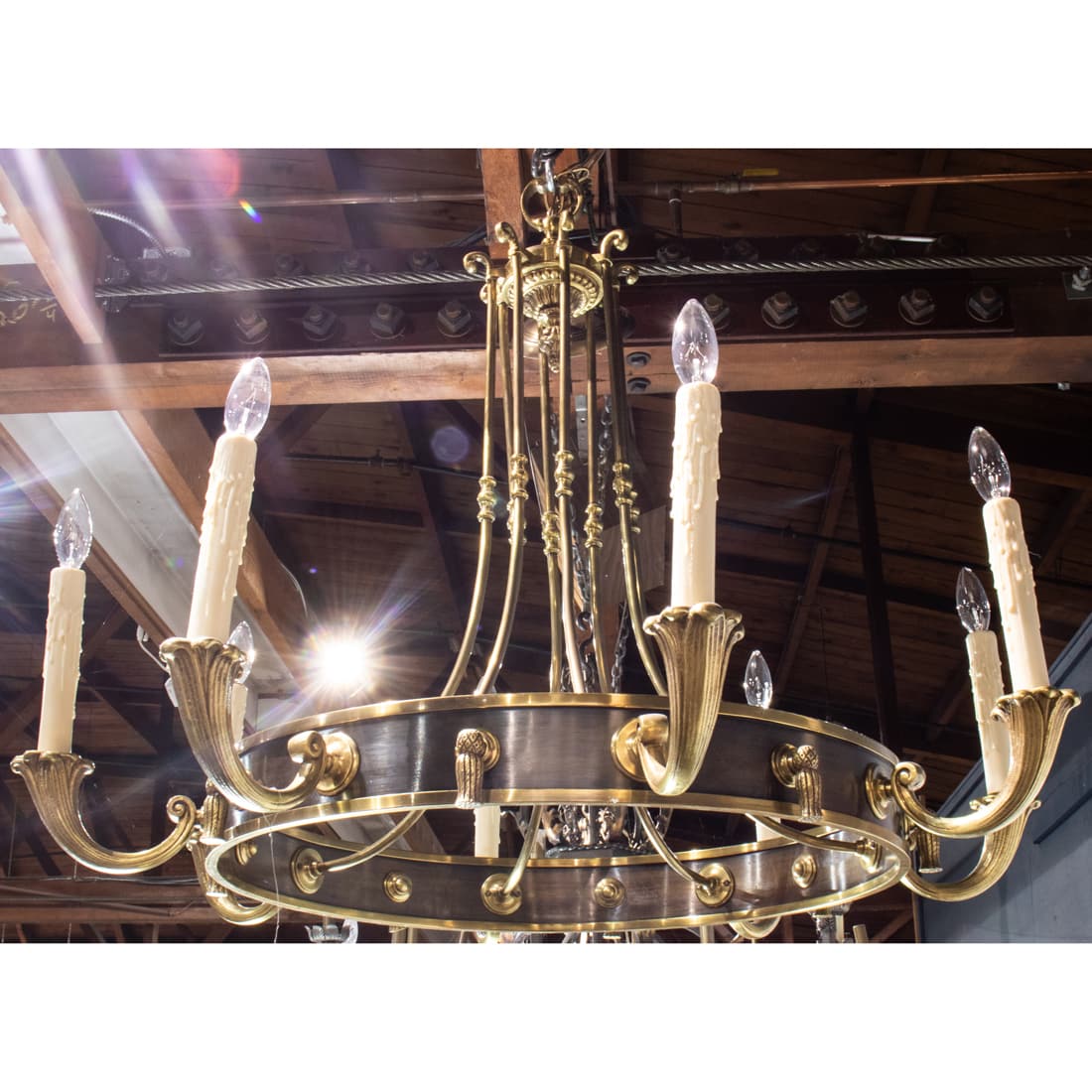 Gilt and brushed metal chandelier in the French taste: Gilt and brushed metal chandelier in the French taste, with eight lights surrounding the circular mounts, and suspended from the outswept supports, 33"h x 36"w