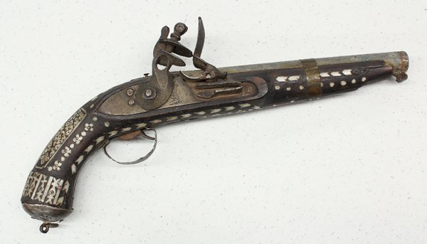 Middle Eastern flintlock: Middle Eastern flintlock pistol, 19th century, with an 8.5'' barrel, the lock with engraved marks, the stock and ball butt decorated with metal, and inlaid mother-of-pearl