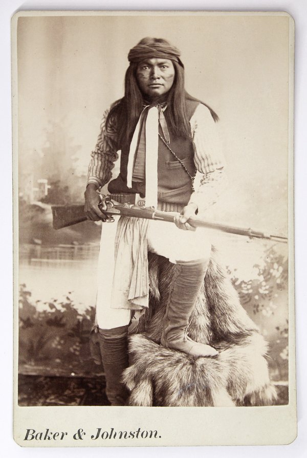 Cabinet Card, Apache, Baker and Johnston: Cabinet card depicting an Apache scout, by Baker and Johnston, inscribed ''Esh-kin-tsay-gizah (Mike) White Mt. Apaches: Al-chi-say's Band'' on label verso, with Baker and Johnston imprint on mount bel