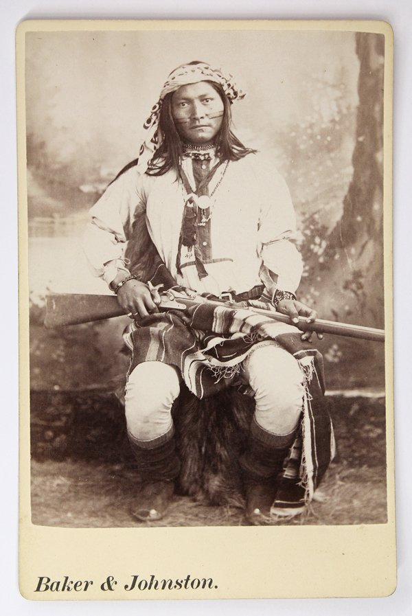 Cabinet Card, Apache, Baker and Johnston: Cabinet card depicting an Apache scout, by Baker and Johnston, inscribed ''Indian scout'' verso, inscribed ''Ba-cluth (Roaming Coyote) Chiracahua Scout: Chatto's Band'' on label verso, with Baker and 