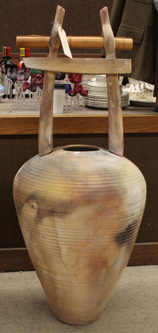 Christianson earthenware studio pottery amphora: Christianson earthenware studio pottery amphora, circa 1990, with a lid, the exterior decorated with a peel-away slip raku glaze, surmounted with a Japanese style torii, 55''h x 22''w