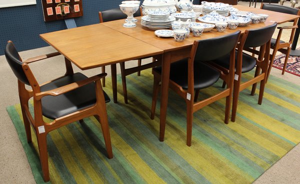 Dyrlund and Smith: Dyrlund & Smith Danish Modern dining suite, executed in teak, consisting of a draw leaf table rising on turned legs, 29''h x 92''w (extended) x 34''d, together with two armchairs and four side chairs,
