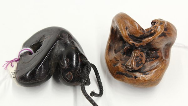 Two Japanese Netsuke: (Lot of 2) Japanese netsuke, the first of umimatsu and preserving the natural configuration of the 'black coral', 2''; the second a 19th century wooden toggle resembling a mask, 1.75''. Provenance: Un