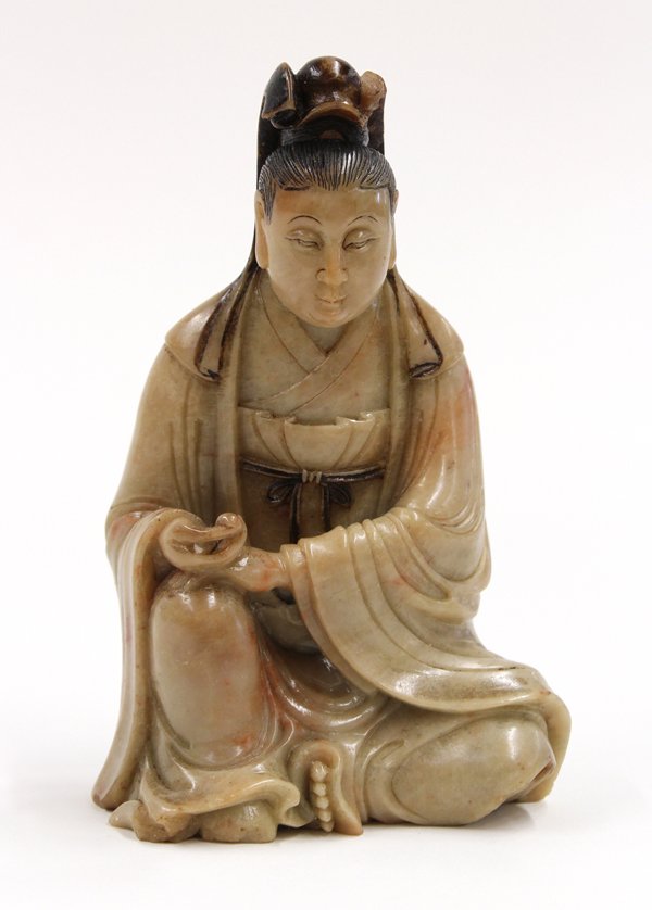 Chinese Soapstone Figure: Chinese soapstone figural carving, carved as a deity, possibly Guanyin, seated in a pose of royal ease and clutching a sacred jewel in one hand, the melon-seed face with downcast eyes, aristocratic no